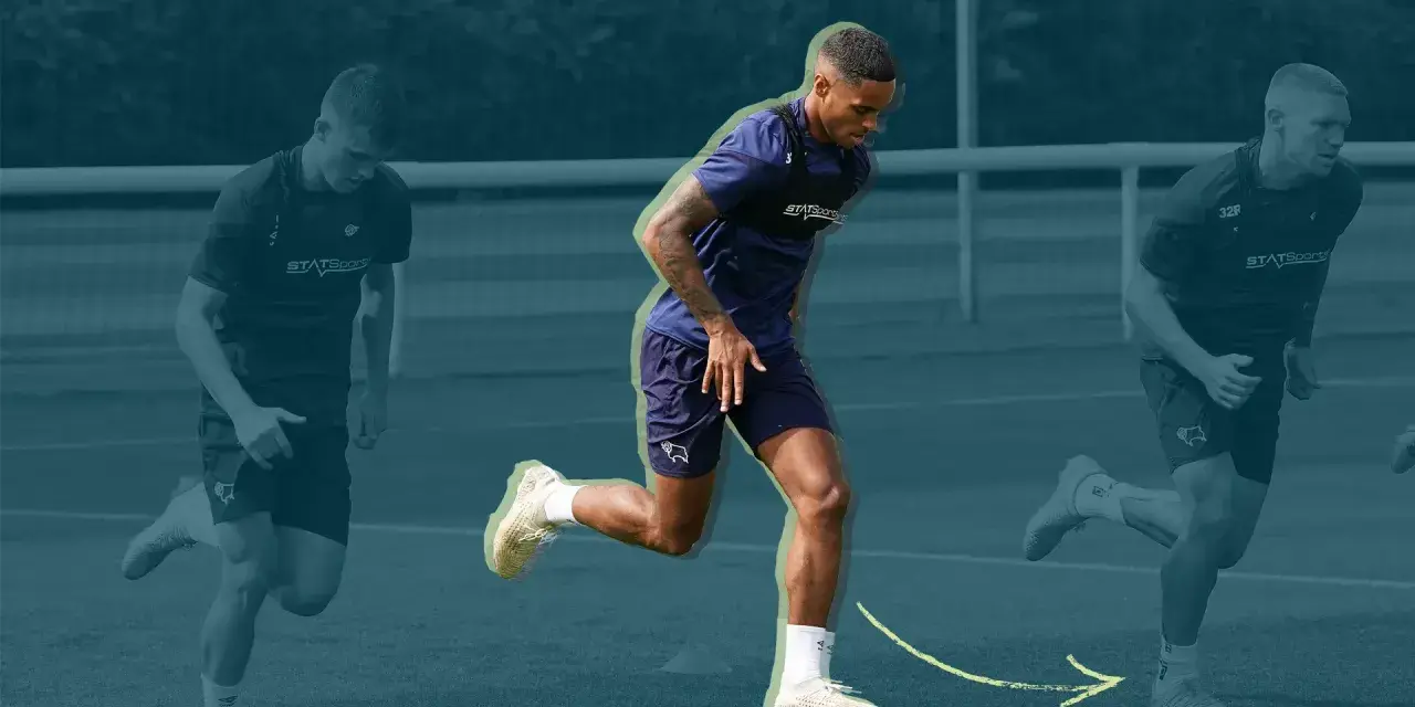 Three soccer players in training gear running on a field, with the central player in focus.