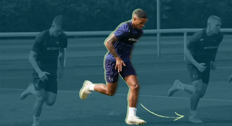 Three soccer players in training gear running on a field, with the central player in focus.