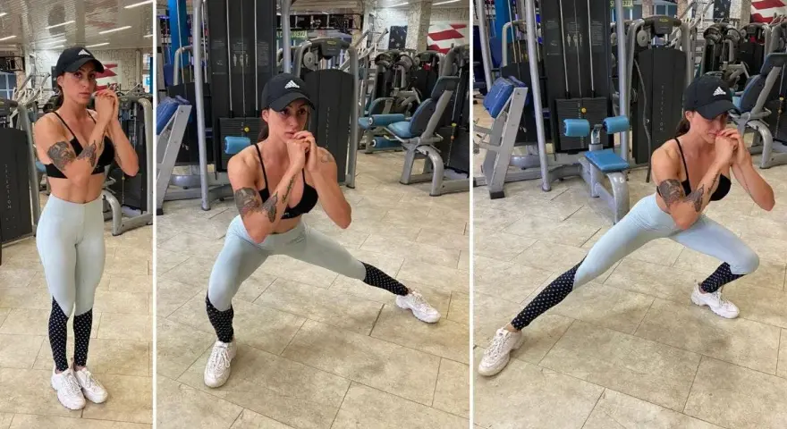 Donna in palestra esegue affondo laterale, lavorando l'adduttore breve.